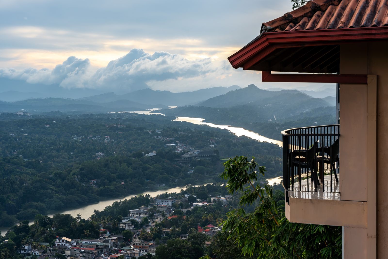 Private balcony looking out over a green valley and a winding river